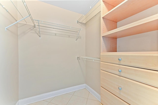 spacious closet featuring light tile patterned floors