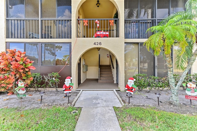 doorway to property featuring stucco siding