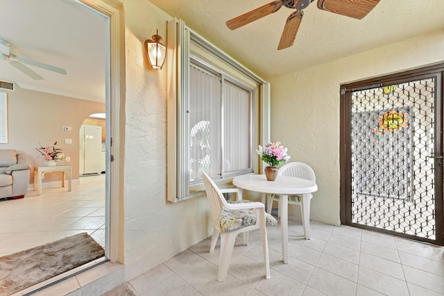 sunroom featuring a ceiling fan, arched walkways, and visible vents