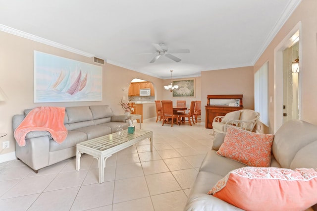 living area featuring arched walkways, visible vents, crown molding, and light tile patterned floors