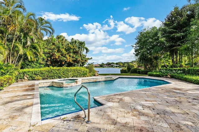 view of pool with a patio area, a water view, and an in ground hot tub