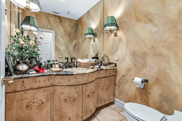 bathroom featuring vanity, tile patterned flooring, and toilet