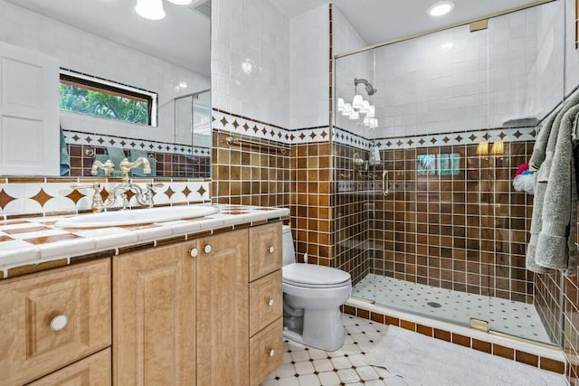 bathroom featuring toilet, tile walls, a tile shower, vanity, and backsplash