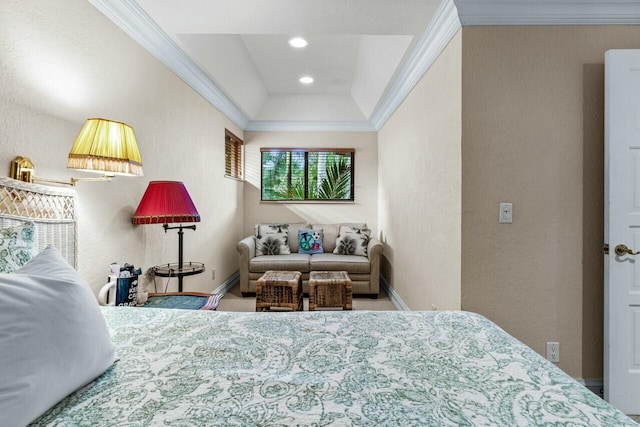 bedroom with ornamental molding and a tray ceiling