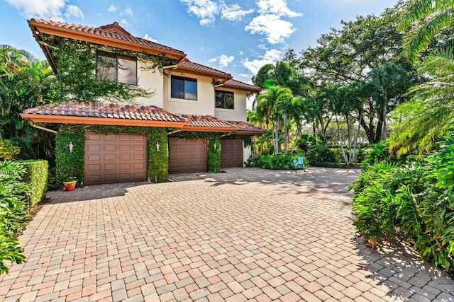 mediterranean / spanish-style home with a garage