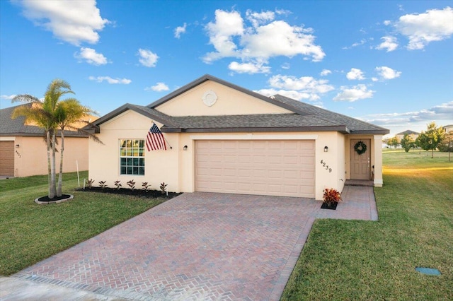 single story home with a garage and a front lawn