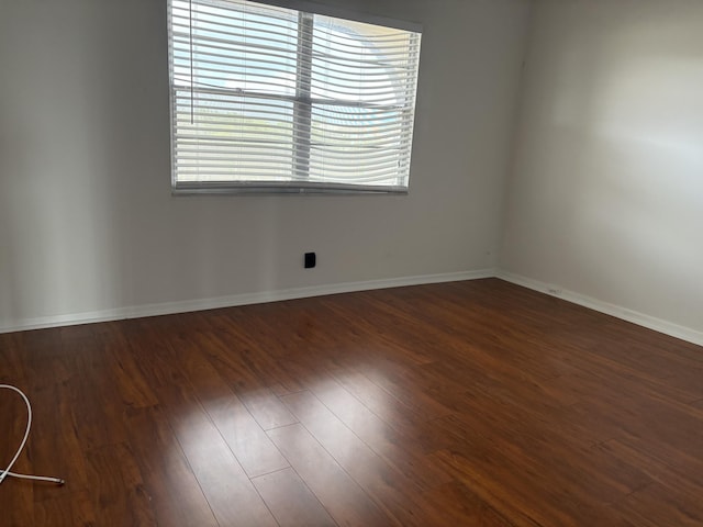 unfurnished room featuring dark wood-type flooring