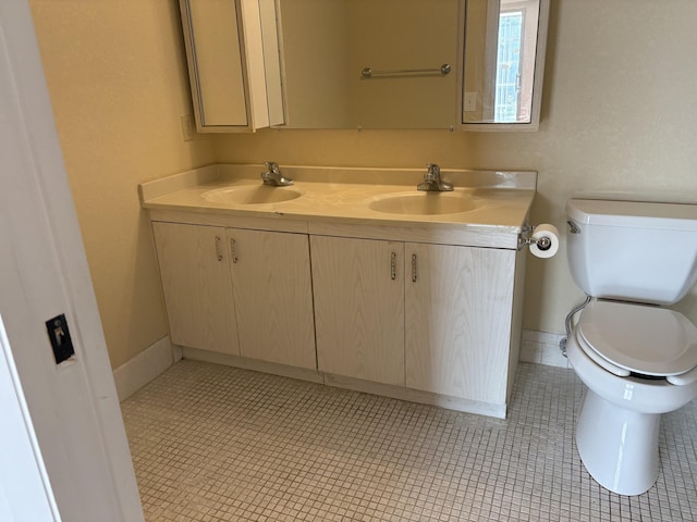 bathroom featuring tile patterned flooring, vanity, and toilet