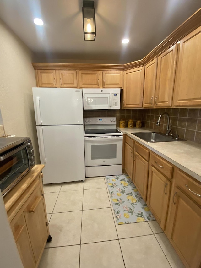 kitchen featuring backsplash, white appliances, sink, and light tile patterned floors