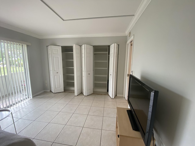 unfurnished bedroom with light tile patterned floors and crown molding