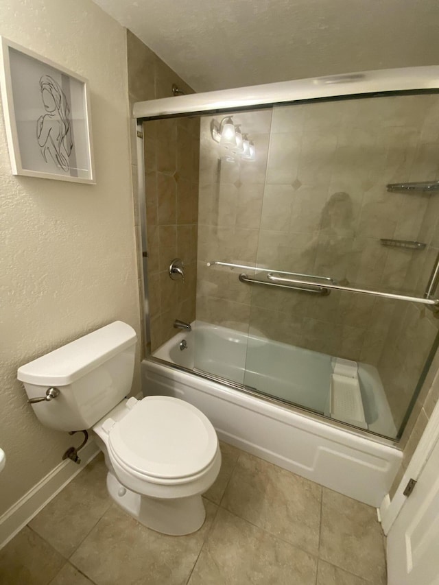 bathroom featuring tile patterned floors, toilet, and combined bath / shower with glass door