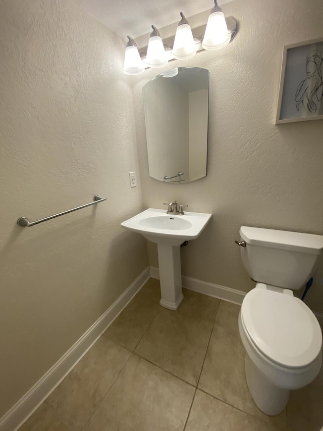 bathroom with tile patterned flooring and toilet