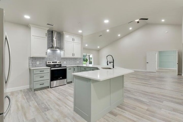 kitchen featuring wall chimney exhaust hood, vaulted ceiling, sink, electric range, and fridge