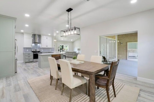 dining area featuring light hardwood / wood-style floors and sink