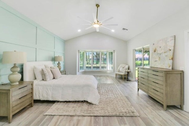 bedroom featuring ceiling fan, light hardwood / wood-style floors, and lofted ceiling