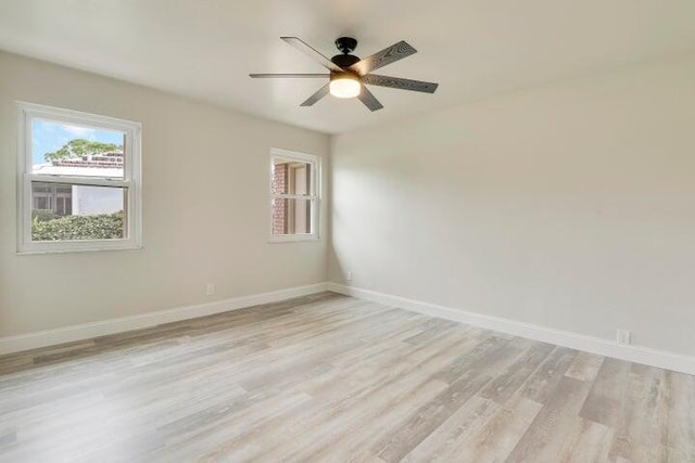 spare room featuring ceiling fan and light hardwood / wood-style flooring