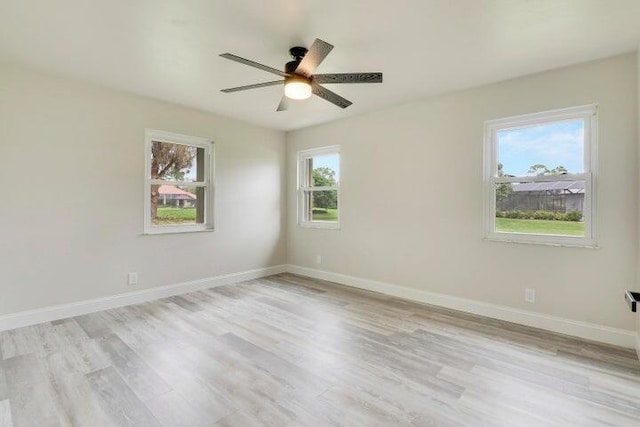 spare room with ceiling fan and light wood-type flooring