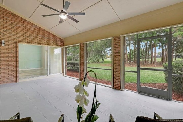 unfurnished sunroom featuring vaulted ceiling and ceiling fan