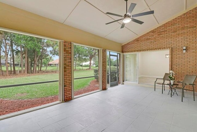 sunroom with ceiling fan and lofted ceiling