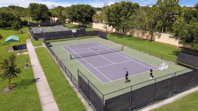 view of tennis court featuring basketball hoop