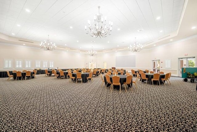 interior space with a raised ceiling, crown molding, carpet flooring, and a towering ceiling