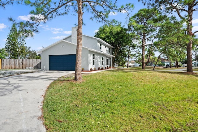 view of side of home featuring a lawn and a garage