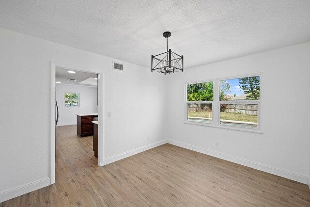 unfurnished room with light wood-type flooring