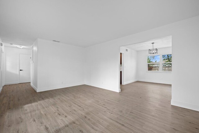 unfurnished bedroom featuring multiple closets, ceiling fan, light hardwood / wood-style flooring, and a textured ceiling