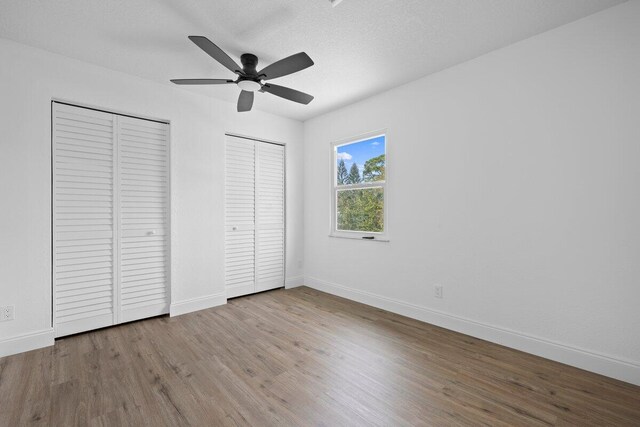 spare room with ceiling fan, light hardwood / wood-style flooring, and a textured ceiling