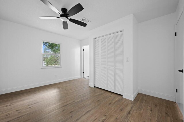 spare room featuring ceiling fan and wood-type flooring