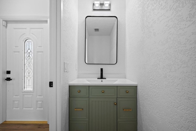 full bathroom featuring vanity, tiled shower / bath combo, a textured ceiling, and toilet