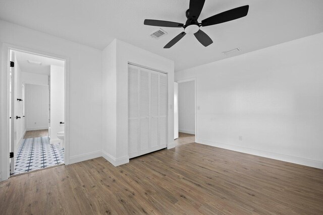 full bathroom with toilet, vanity, a textured ceiling, and tiled shower / bath