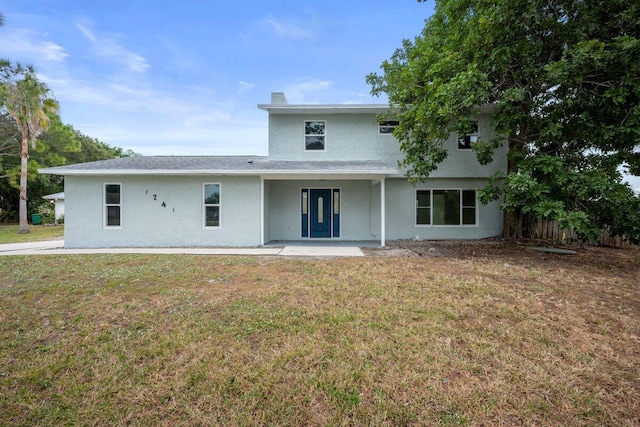 rear view of property featuring a yard and a patio