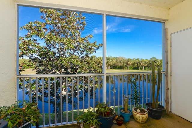 unfurnished sunroom featuring a water view