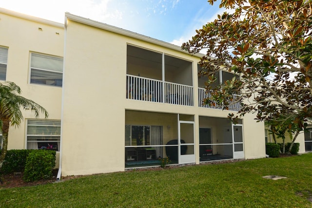 rear view of property with a yard