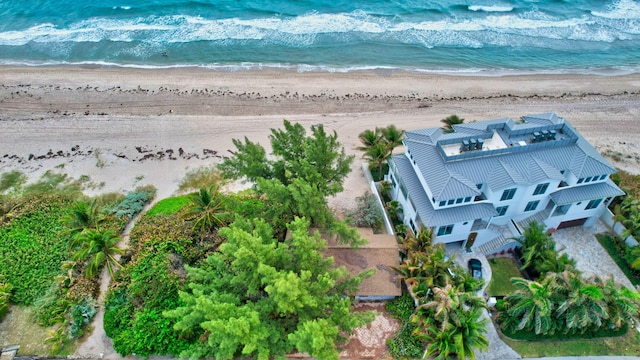 drone / aerial view with a beach view and a water view