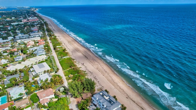 drone / aerial view with a residential view, a beach view, and a water view