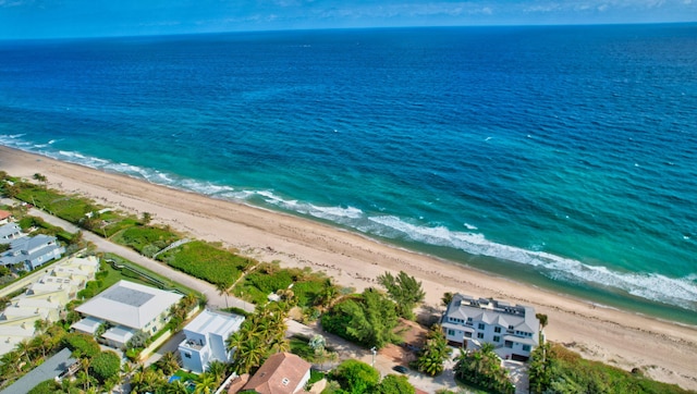 drone / aerial view with a beach view and a water view