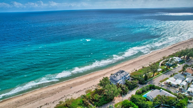 birds eye view of property with a beach view and a water view