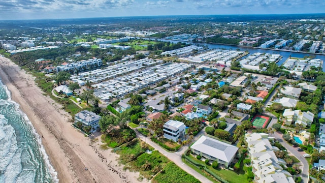 birds eye view of property featuring a water view and a view of the beach