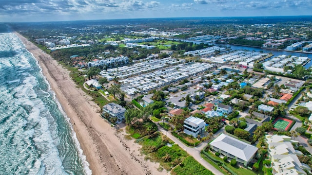 drone / aerial view with a water view and a view of the beach