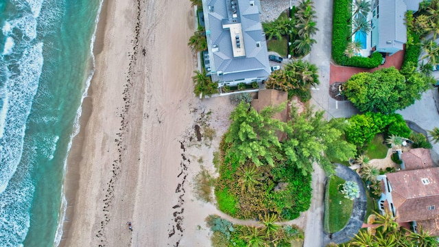 bird's eye view with a water view and a beach view