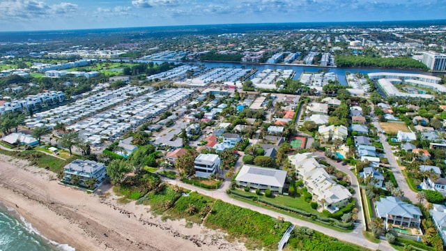 birds eye view of property with a water view and a view of the beach