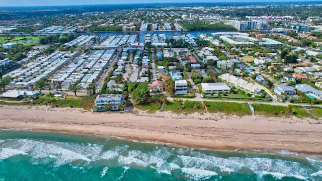 bird's eye view featuring a water view and a beach view