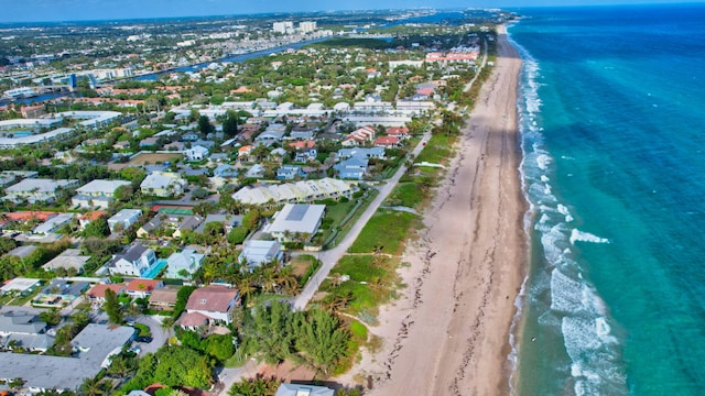 drone / aerial view with a beach view and a water view