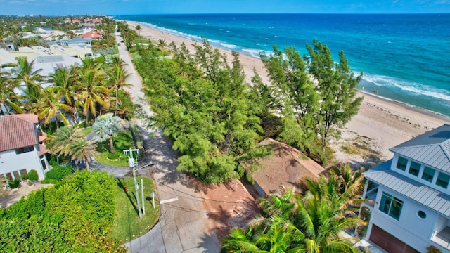 bird's eye view with a water view and a beach view