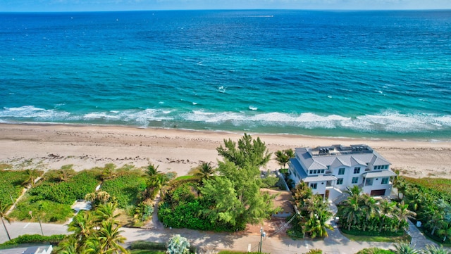 birds eye view of property featuring a beach view and a water view