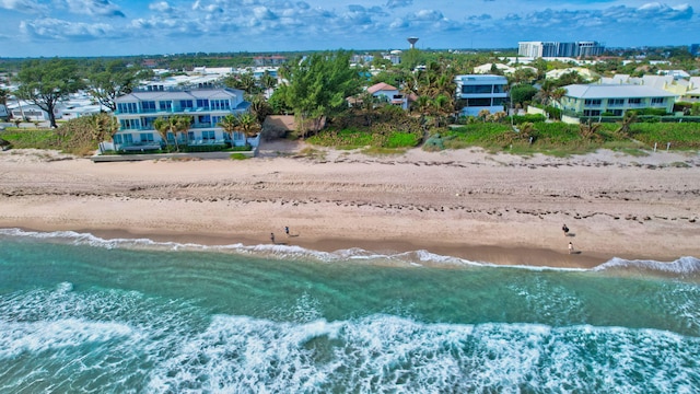 birds eye view of property with a water view and a view of the beach