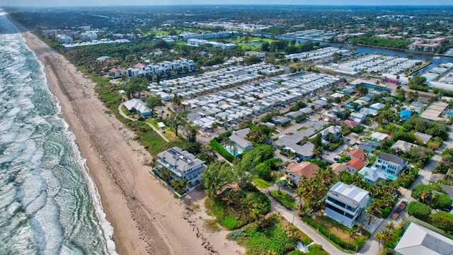 birds eye view of property with a water view and a view of the beach