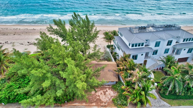 drone / aerial view with a water view and a beach view